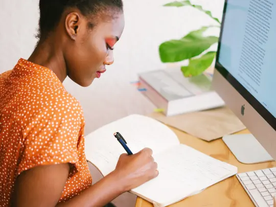 woman-in-front-of-her-computer-writing