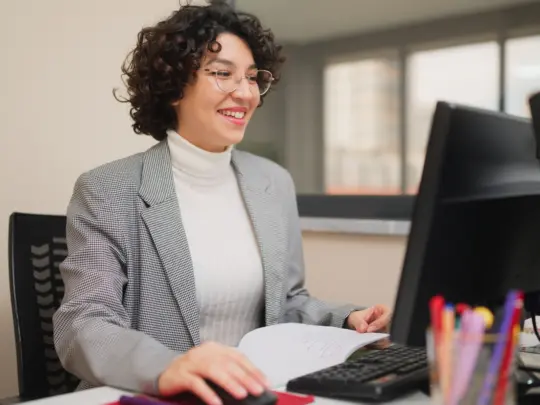 Female teacher working on computer